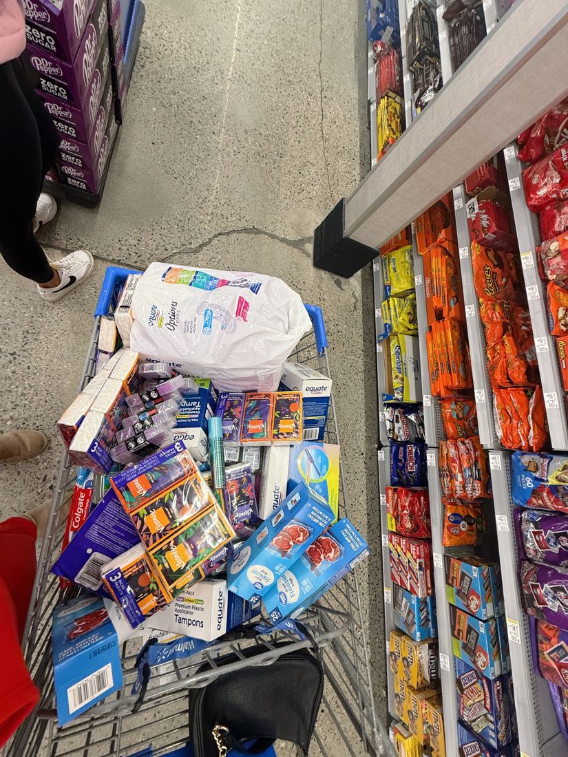 A cart loaded with tampons, pads, tissues and toothpaste