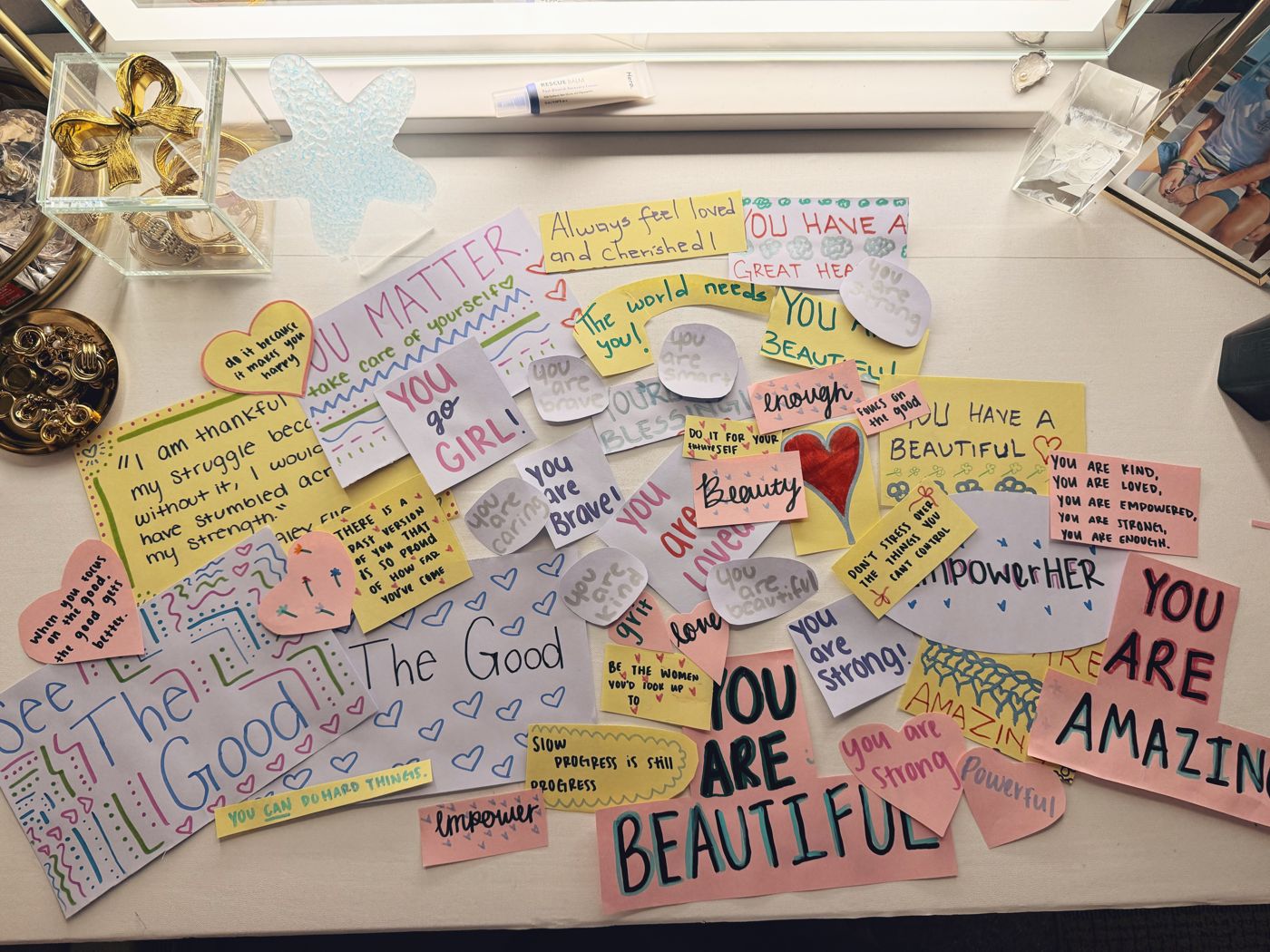 Dozens of handwritten affirmation notes reading You are beautiful, You matter, You go girl, and more